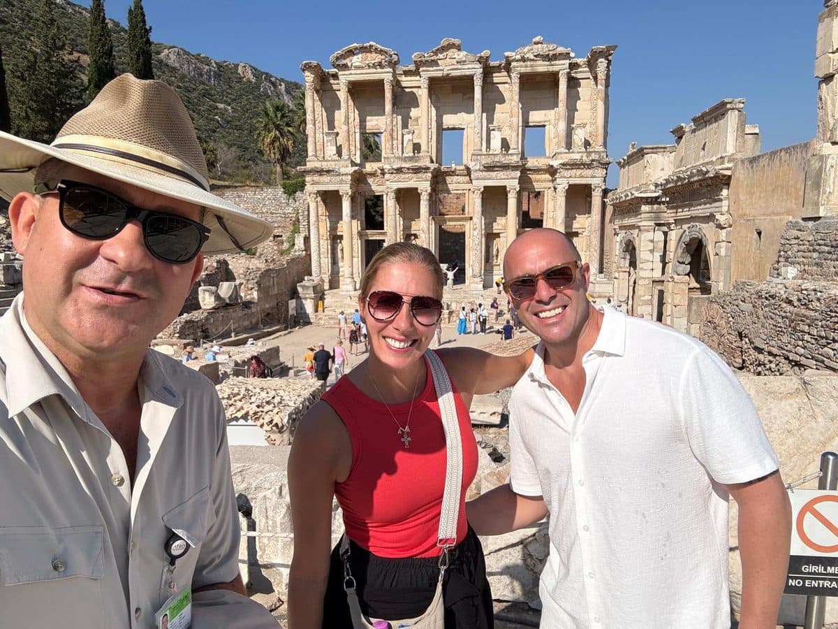 Two American guests from the Ritz-Carlton yacht Evrima with their licensed English- and Russian-speaking guide Mehmet Tunalı in front of the Library of Celsus on a private half-day Ephesus and House of the Virgin Mary tour in English from Kuşadası cruise port, 21 September 2026